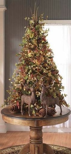 a christmas tree with two deer figurines on top