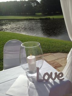 a table with a candle on it and the word love written in front of it