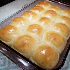 a baking pan filled with bread on top of a table