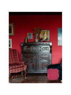 a living room with red walls and furniture