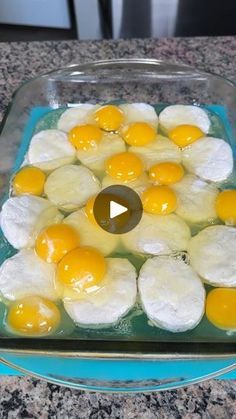 a glass dish filled with eggs on top of a counter