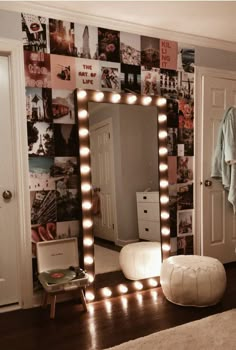 a room with a mirror, stool and lights on the wall behind it in front of a door