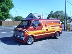 an orange and yellow van is parked on the street