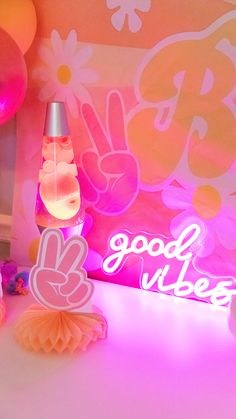 there are balloons and decorations on the table in front of the sign that says good vibes