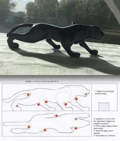 a black cat figurine with red dots on it's body