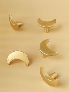 four different types of brass door handles on a beige background