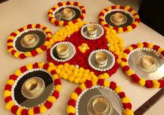 a table topped with lots of plates covered in flowers and gold dishes on top of it