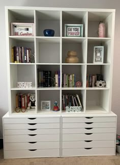 a white bookcase filled with lots of books