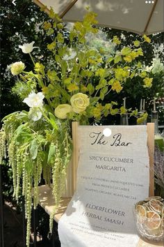 a table topped with flowers and an umbrella