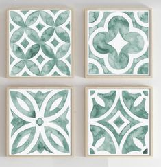 four green watercolor paintings hanging on the wall