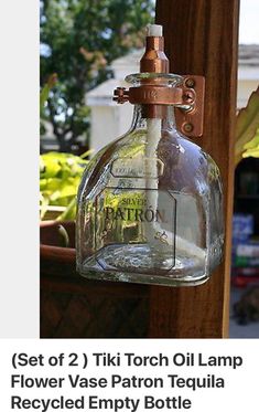 an old fashioned glass bottle hanging from a wooden pole