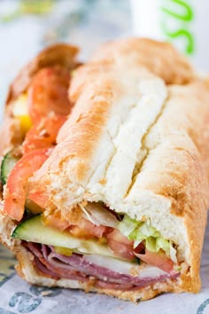 a close up of a sandwich with meat and veggies