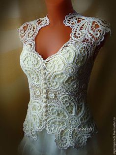 a mannequin wearing a white lacy top