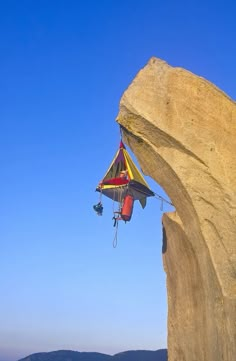 a man hanging from a parachute over the ocean