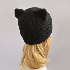 a wig wearing a black knitted cat hat