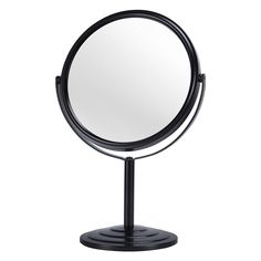 a round mirror sitting on top of a metal stand