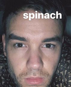 a man is staring at the camera with spinach on his forehead and in front of him