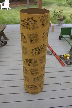 a large roll of construction paper sitting on top of a wooden deck