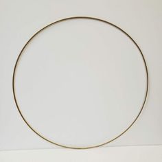 a gold colored metal circle on a white background with space for your text or image