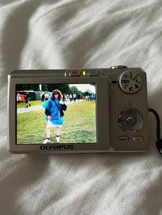 a digital camera sitting on top of a bed