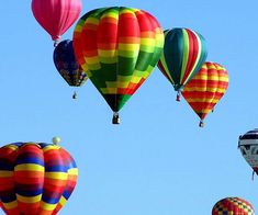 many colorful hot air balloons flying in the sky