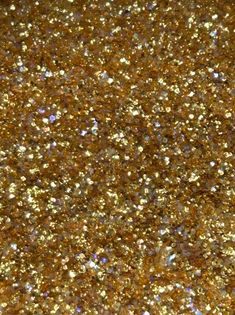 gold glitter textured background with lots of small sparkles on the top and bottom