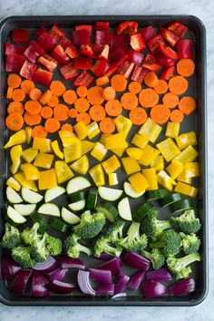 a tray filled with cut up vegetables on top of a table