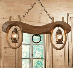 a wooden chandelier with two lights hanging from it