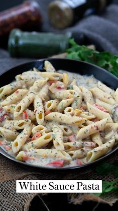 creamy white sauce pasta in a black bowl