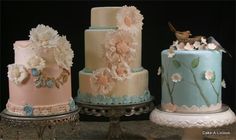 three tiered cakes with flowers and birds on them