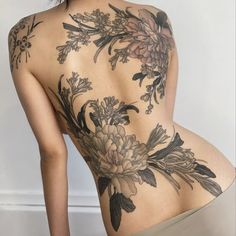 the back of a woman's body with flowers on it