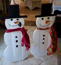 two snowmen are standing next to each other