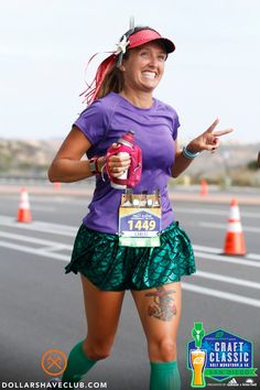 a woman in purple shirt and green skirt running