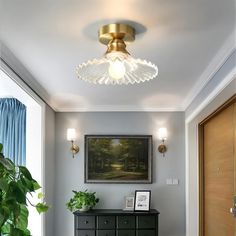 a living room with a painting on the wall and a black dresser in front of it