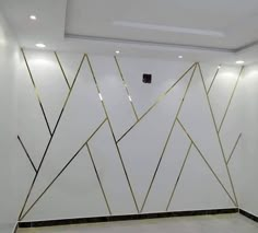 a white room with gold lines on the wall