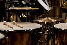 a drum set up in front of a musical instrument