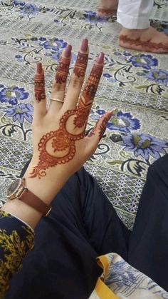 a woman's hand with henna on it