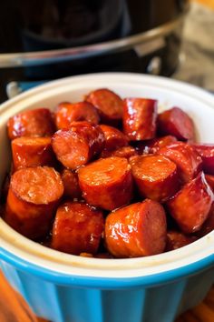 a bowl filled with cooked carrots on top of a wooden table