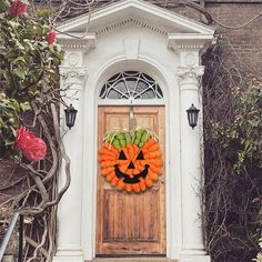 a wooden door with a pumpkin wreath on it