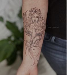 a woman's arm with a tattoo on it and a bird in the middle