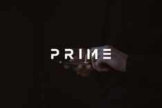 a person holding a cell phone with the word prime on it