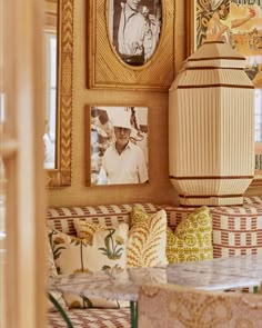 a living room filled with furniture and pictures on the wall