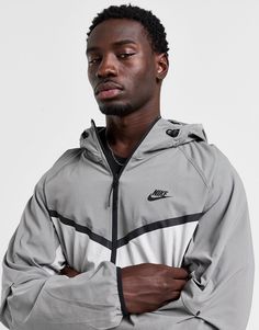 Layer up in signature Swoosh style with this men's Tech Woven Full Zip Hooded Jacket from Nike. In a Light Iron Ore and White colour block design, this relaxed-fit jacket is made with smooth, durable woven nylon fabric with added stretch for lasting comfort. It features a full-zip closure with stand collar and hood to amp up the coverage, while an elastic binding around the trims secures the fit. It has articulated elbows for a dynamic feel, and zipped pockets to stash your essentials. Finished with contrast taping to create the iconic Chevron design, and the legendary Swoosh logo at the chest. Machine washable. | Our model is 6'0" with a 36" chest and wears a size medium. Black Nike Tech, Chest Machine, Iron Ore, Chevron Design, Nike Tech, Swoosh Logo, Grey Nikes, Black Nike, Block Design