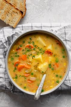 a bowl of soup with bread on the side