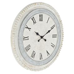 a white clock with roman numerals on the face