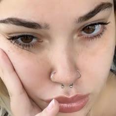 a close up of a person with a nose piercing