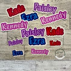 the name stickers are all in different colors and sizes, including red, blue, purple