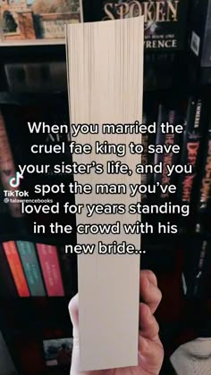 someone is holding up a book in front of bookshelves with the quote when you married the cruel fire king to save your sisters life, and you