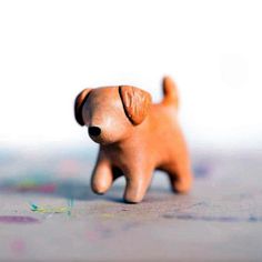 a small wooden dog figurine sitting on top of a table