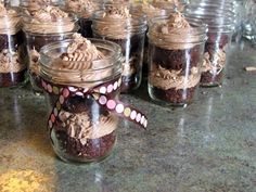 there are many jars filled with brownies and cookies in them on the counter top